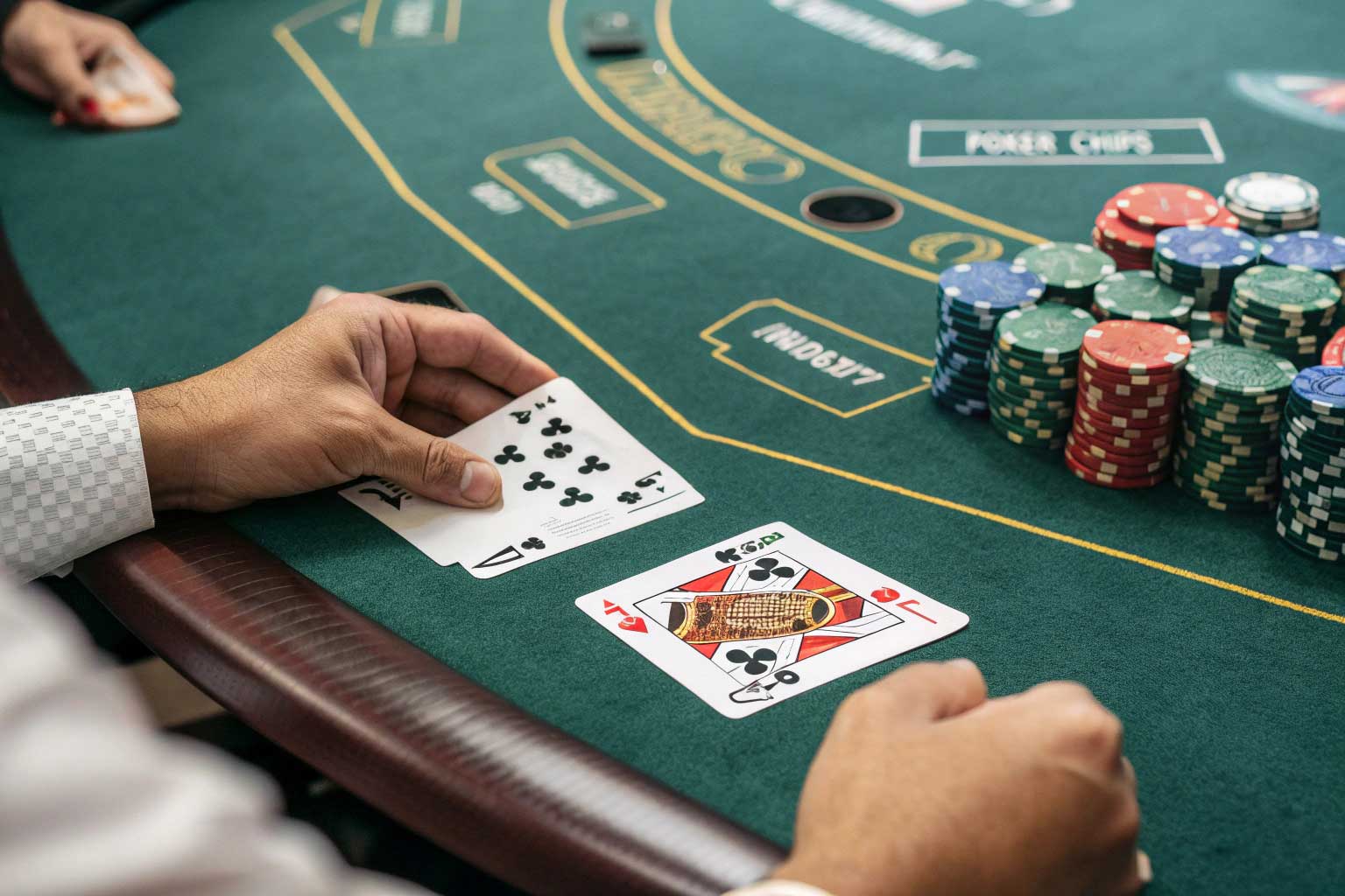 Blackjack Basic Strategy in Action - 0.5% House Edge Blackjack table showing player cards dealer cards and strategy chart with poker chips